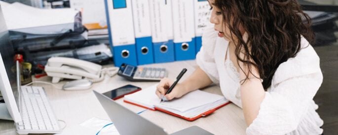 Photo by Anna Tarazevich: https://www.pexels.com/photo/woman-writing-on-notebook-while-using-laptop-5196821/