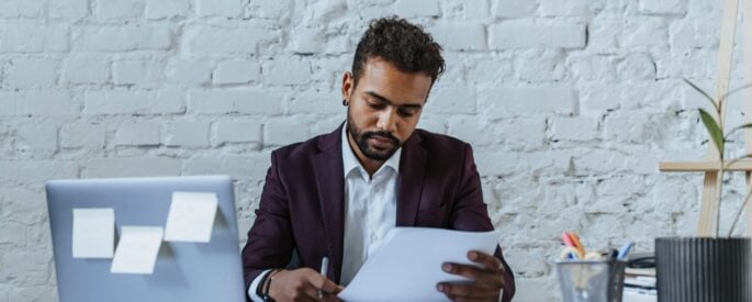 Photo by olia danilevich: https://www.pexels.com/photo/man-in-black-suit-looking-the-document-5313175/